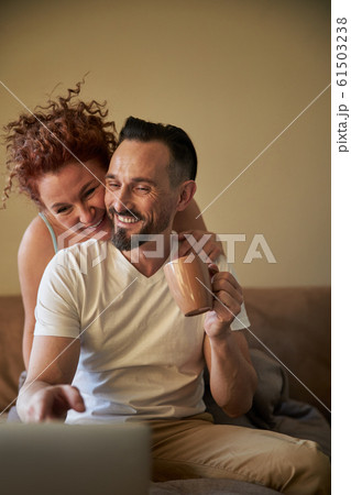 Happy adult lady hugging man in bedroom 61503238