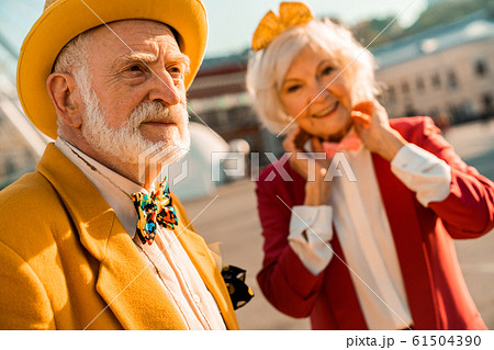 Senior male looking away while walking with wife Senior male looking away while walking with wife 61504390