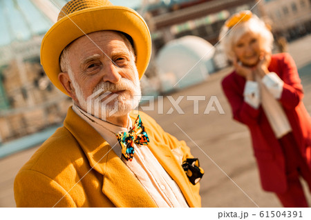 Smiling old man in hat looking at camera outdoors Smiling old man in hat looking at camera outdoors 61504391