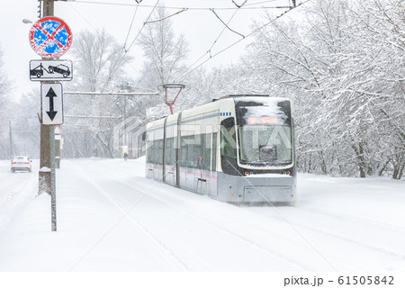 Winter road in Moscow, Russia. Frozen modern tram Winter road in Moscow, Russia. Frozen modern tram 61505842