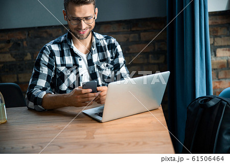Attractive Caucasian male sitting in co-working space Attractive Caucasian male sitting in co-working space 61506464