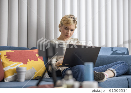 Young pretty woman working in room while typing 61506554
