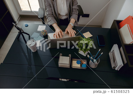 Cropped photo of female hands on laptop in the office Cropped photo of female hands on laptop in the office 61508325