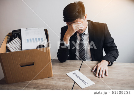 Male employee was sad at his desk when he received 61509252