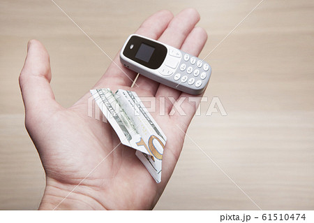 mobile phone money hand table background mobile phone money hand table background 61510474