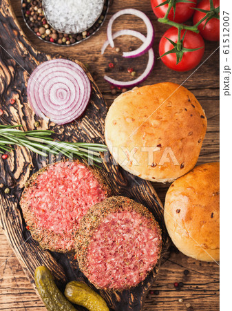 Fresh raw minced pepper beef burgers on vintage 61512007