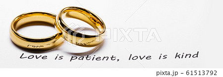 Golden wedding rings on bible phrase 61513792