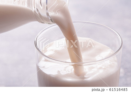 Pouring milk into a glass 61516485