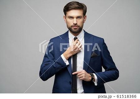 studio photo of young handsome stylish businessman wearing suit 61518366