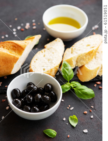 Sliced fresh crusty baguette with olive and spices 61519051