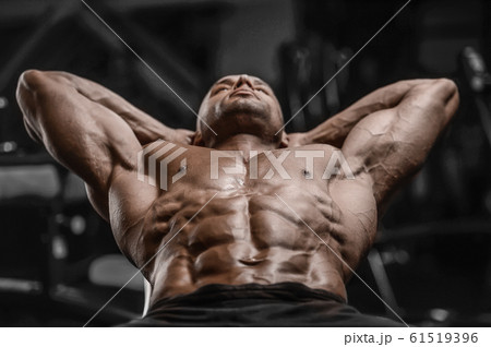 Handsome strong athletic men pumping up muscles Handsome strong athletic men pumping up muscles 61519396