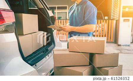 hai mailman checking parcel and mail boxes for 61526352