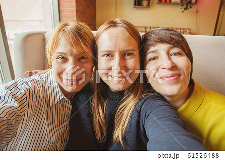 Happy women taking selfie photo 61526488