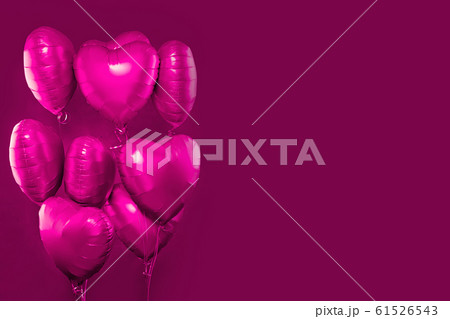 Pink heart balloons on bright pink card background Pink heart balloons on bright pink card background 61526543