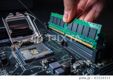 Electronic engineer of computer technology. Maintenance computer hardware upgrade of motherboard putting the Ram on the motherboard computer. Concept of PC memory upgrade. Electronic engineer of computer technology. Maintenance computer hardware upgrade of motherboard putting the Ram on the motherboard computer. Concept of PC memory upgrade. 61528313