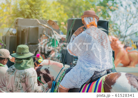 Young man riding horse with music band in ordination ceremony in buddhist Thai monk ritual for change man to monk in ordination ceremony in buddhist in Thailand 61528341