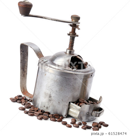 Manual coffee mill on roasted coffee beans 61528474