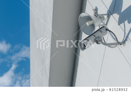 Loudspeakers and CCTV security cameras observation on a wall of a building Loudspeakers and CCTV security cameras observation on a wall of a building 61528932