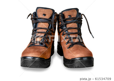 Pair of new modern high brown leather hiking boots isolated on white background. Two trekking rough warm winter footwear shoes. Male outdoor travel and activities equipment 61534709