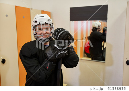 Cheerful Female Hockey Player 61538956