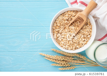 Oats and oat milk on blue wooden background 61539761