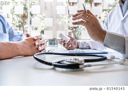 Male doctors explain and recommend treatment with a prescription after the patient meets a doctor and receives results regarding illness problems 61540143