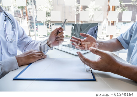 The male doctor sat and checked the patient's history and listened to the patient to clarify the symptoms. Concepts of treatment and good health 61540164