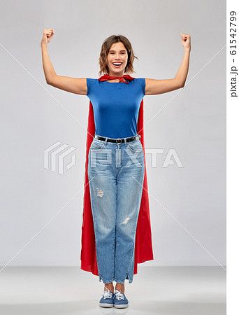 happy woman in red superhero cape showing power 61542799