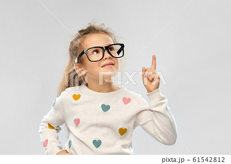 portrait of girl in glasses pointing finger up 61542812