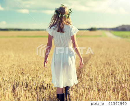 happy young woman in flower wreath on cereal field happy young woman in flower wreath on cereal field 61542940