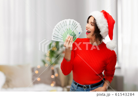 happy woman in santa hat with money on christmas happy woman in santa hat with money on christmas 61543284