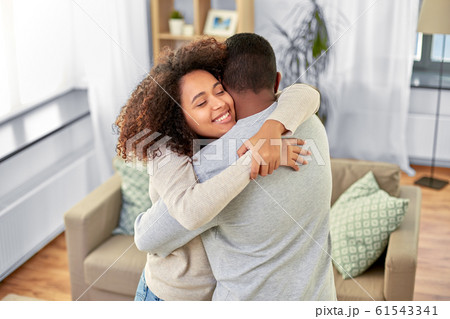 happy african american couple hugging at home happy african american couple hugging at home 61543341