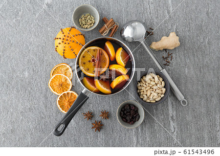 pot with hot mulled wine, orange slices and spices 61543496