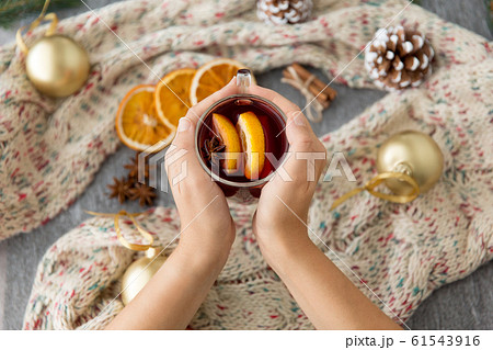 hands with glass of hot mulled wine on christmas hands with glass of hot mulled wine on christmas 61543916