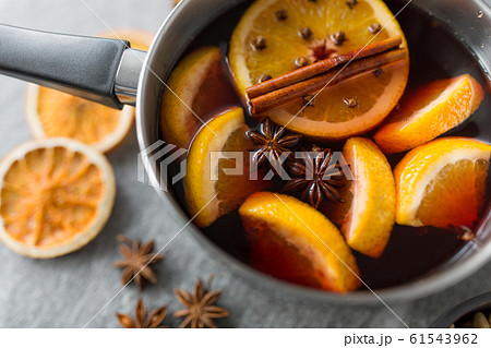 pot with hot mulled wine, orange slices and spices 61543962