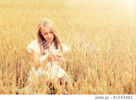 happy woman with smartphone and earphones 61543982