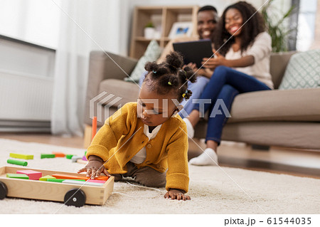 african baby girl playing with toy blocks at home african baby girl playing with toy blocks at home 61544035