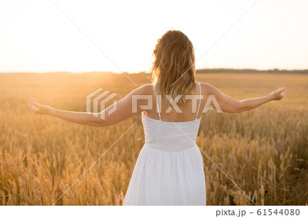 happy woman enjoying freedom on cereal field happy woman enjoying freedom on cereal field 61544080