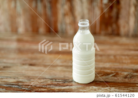 bottle of milk on wooden table bottle of milk on wooden table 61544120
