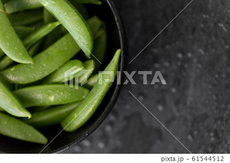 peas in bowl on wet slate stone background peas in bowl on wet slate stone background 61544512