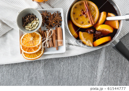 pot with hot mulled wine, orange slices and spices pot with hot mulled wine, orange slices and spices 61544777