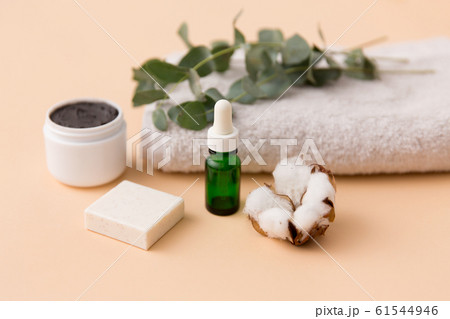 serum, clay mask, oil and eucalyptus on bath towel 61544946