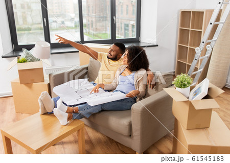 couple with boxes and blueprint moving to new home couple with boxes and blueprint moving to new home 61545183