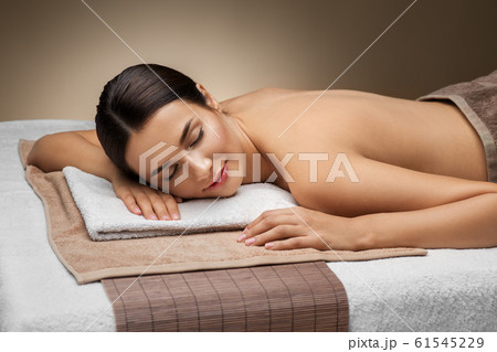 young woman lying at spa or massage parlor 61545229