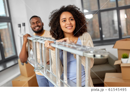 happy couple with ladder moving to new home 61545495