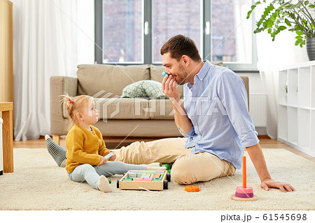 father playing with little baby daughter at home father playing with little baby daughter at home 61545698