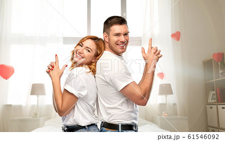 happy couple making gun gesture on valentines day 61546092