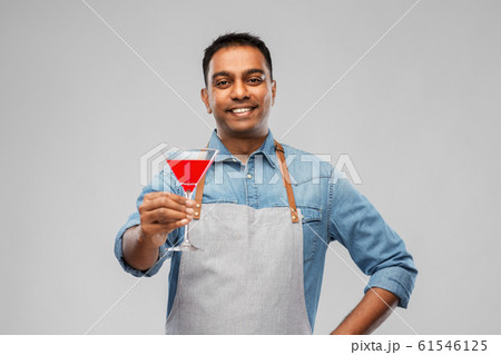 indian barman in apron with glass of cocktail 61546125