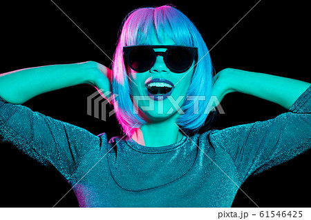happy woman in pink wig and black sunglasses 61546425