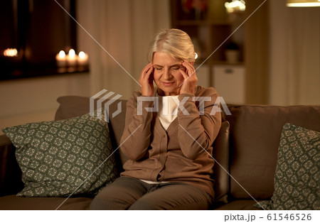 unhappy senior woman suffering from headache unhappy senior woman suffering from headache 61546526